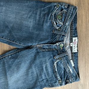 Patina hardware detail. Embroidered pockets. Straight leg denim. A fashion gem!